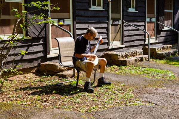 A guest playing the banjo at Big Meadows Lodge